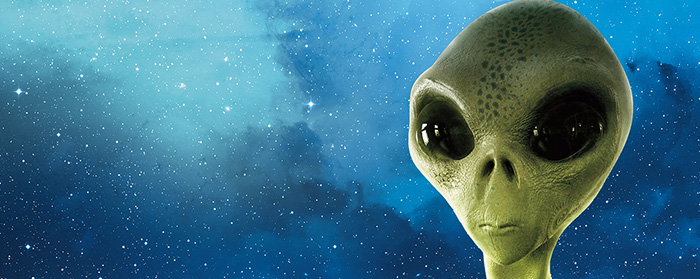 A green alien with large eyes in outer space