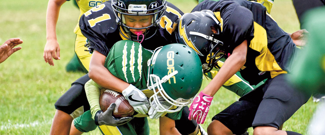 a football player being tackled by the other team