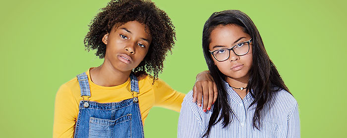 Two girls frowning with unamused looks