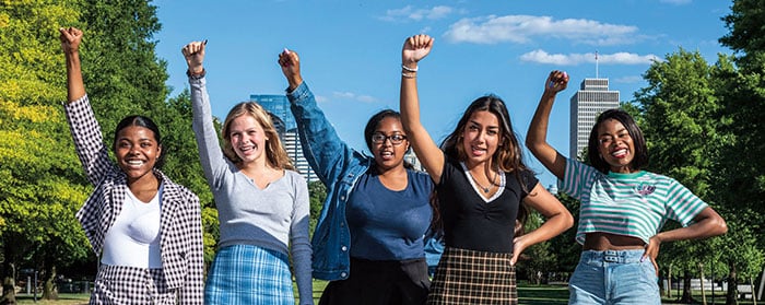 Five women with their fists in the air