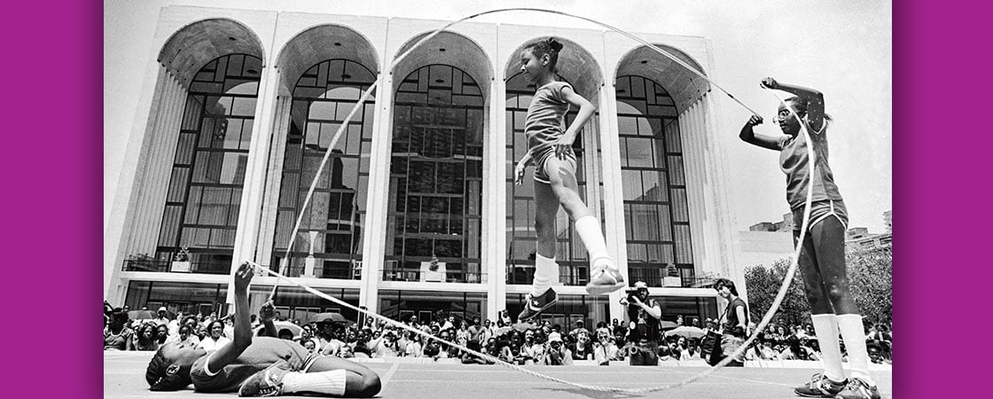 Black and white photo of three girls playing double dutch