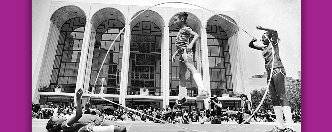Black and white photo of three girls playing double dutch