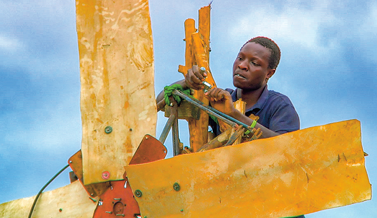 Photo of a teen working on a windmill he created