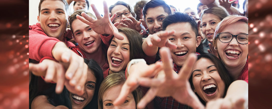 Image of a crowd of excited fans with outstretched arms
